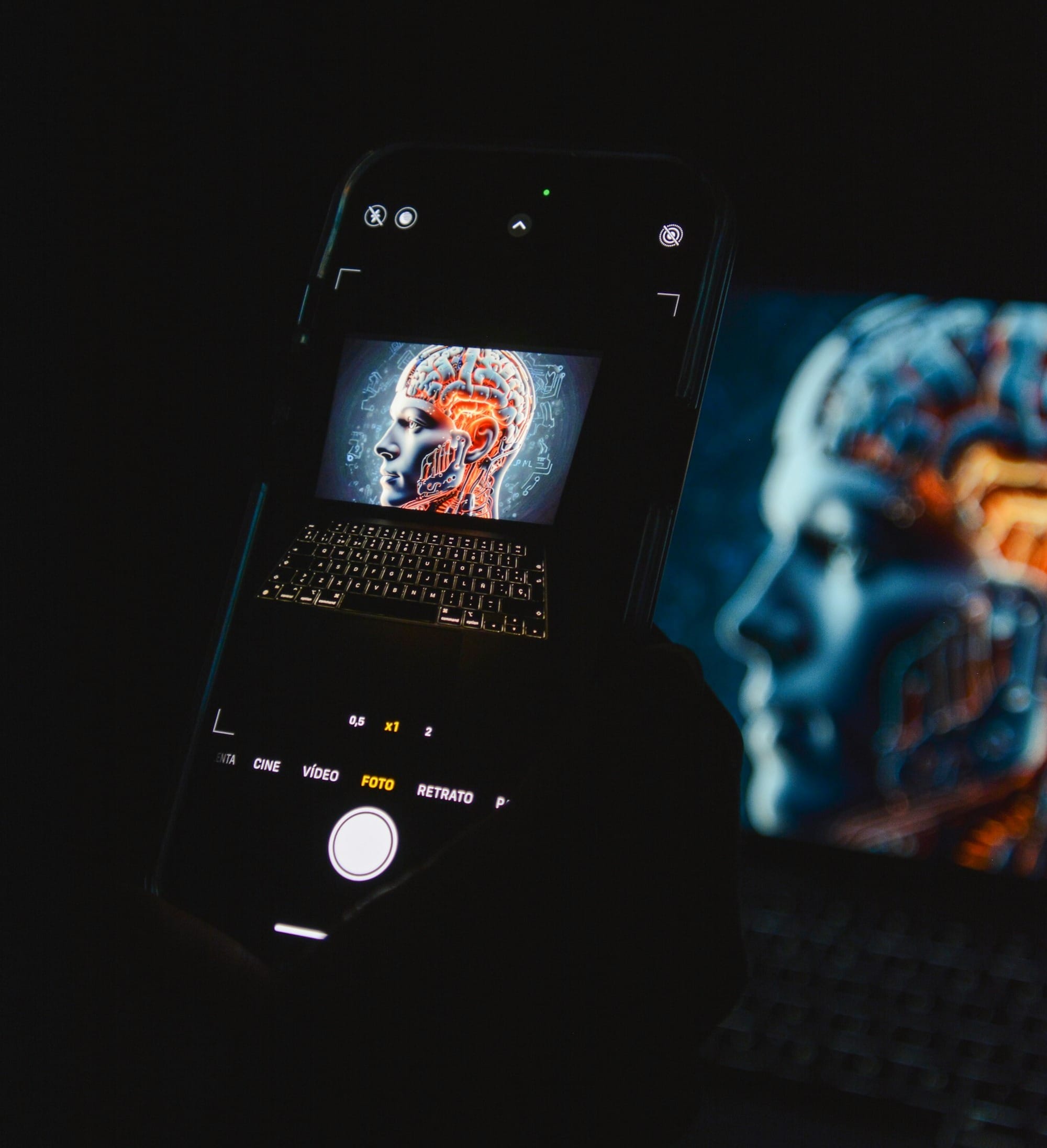 a cell phone sitting on top of a laptop computer